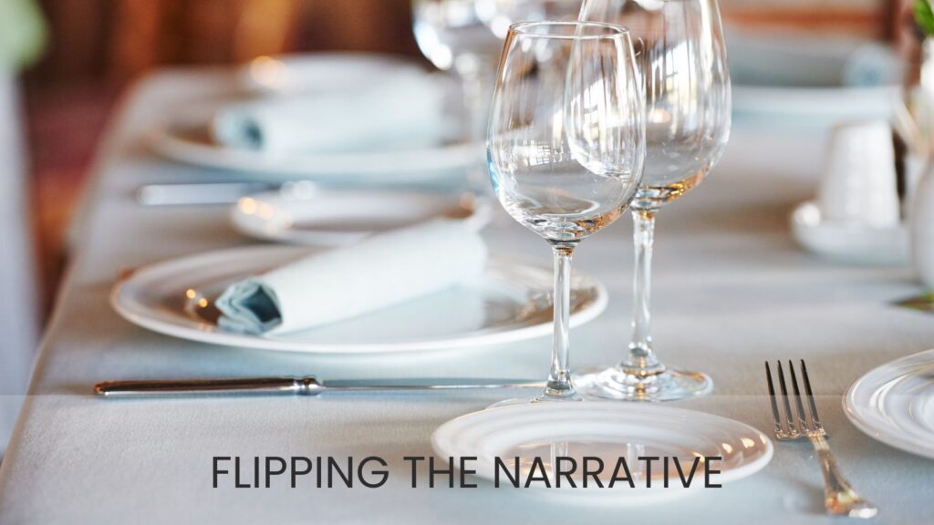 Table with white linens, white china, and empty wine glasses