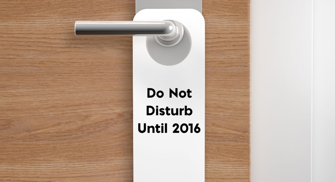 Hotel Door with Sign Text: Do Not Disturb Until 2016
