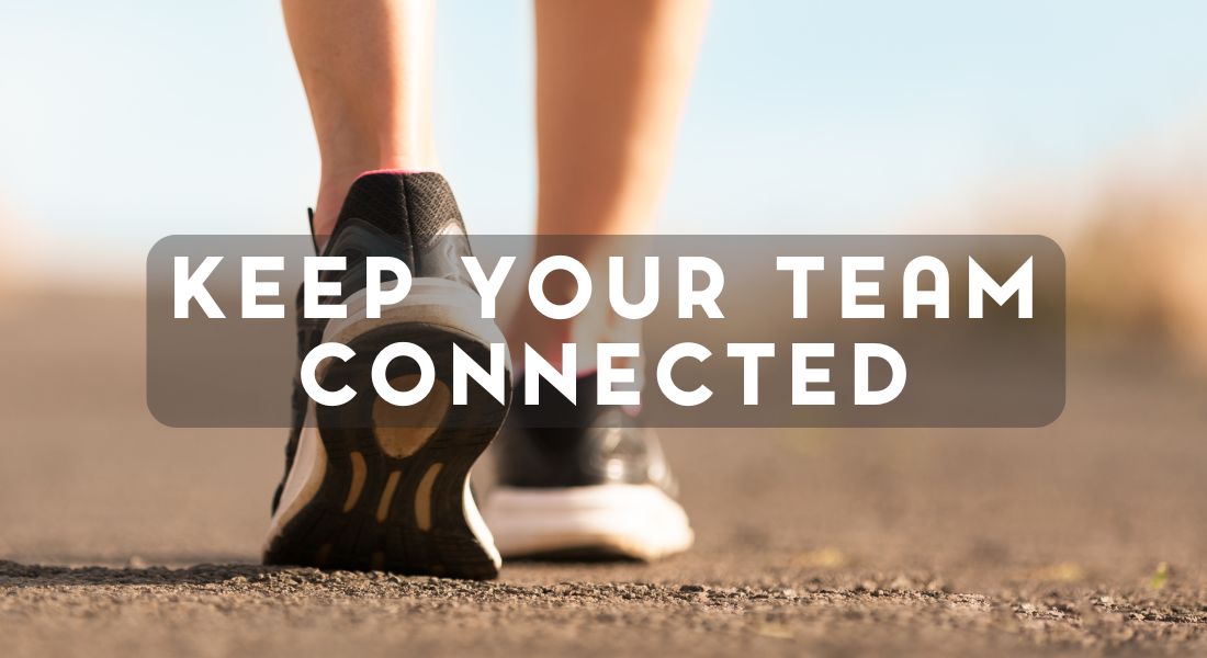 Close-up of a person's feet in sneakers walking on a road with the text "Keep Your Team Connected" overlaying the image.