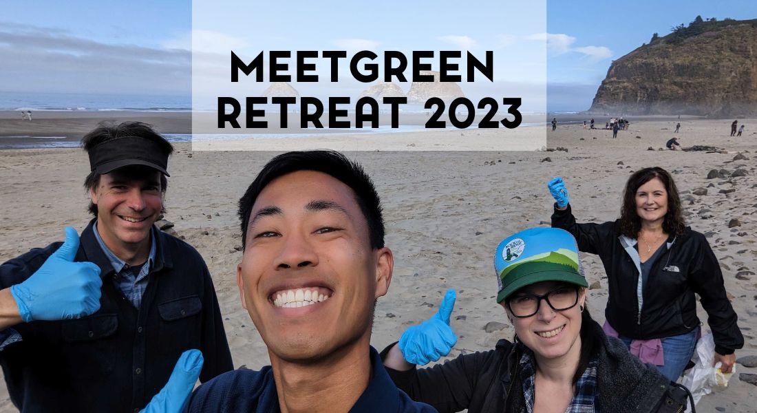 MeetGreen Retreat 2023 4 people on the beach with their thumbs up and smiling