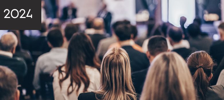 A group of people watching a speaker